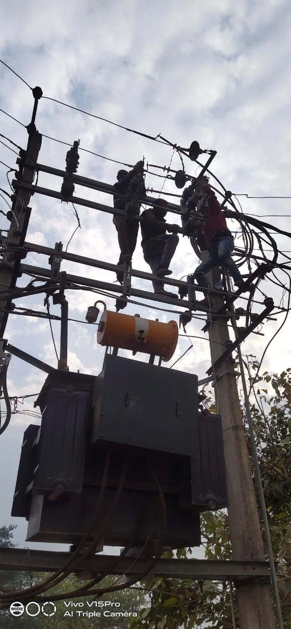 Morlatis line crew working on an 11 kV distribution structure